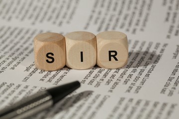 colored wooden cubes with letters. the word sir is displayed, abstract illustration