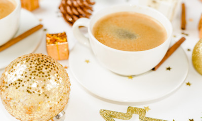 Creative natural layout of Christmas decorations with cups of coffee on a white background.