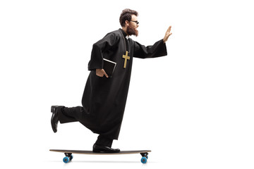 Young priest holding a bible and riding a longboard