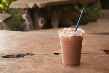 Iced chocolate milkshake, Summer refreshment drinks on wooden background in cafe