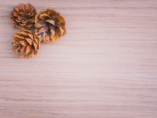 home decoration for new year and christmas concept from red gold and green shades in your home during the holidays and experience the christmas and new year mood with brown pine cone and ball on wood