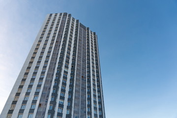 Multi-storey residential building against the blue sky.