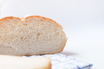 Fresh home made bread on white table background with napkin