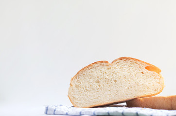 Fresh home made bread on white table background with napkin