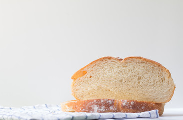 Fresh home made bread on white table background with napkin