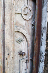 Vintage style steel handle on old wooden door.
