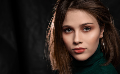 Young Woman with beautiful eyes, Face shot on Dark Grey Background