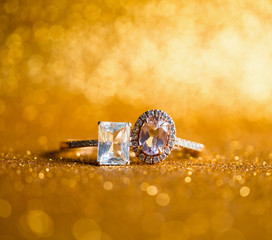 Jewelry diamond ring with abstract festive glitter Christmas holiday texture background blur with bokeh light