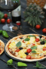 Pineapple pizza served with wine