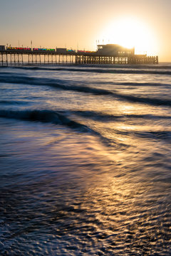 Beautiful vibrant sunrise landscape image of Worthing pier in West Sussex during Winter