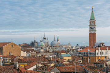 Naklejka premium Basilica di San Marco and roofs of the old venetioan buildings at sunset in Venice, Italy