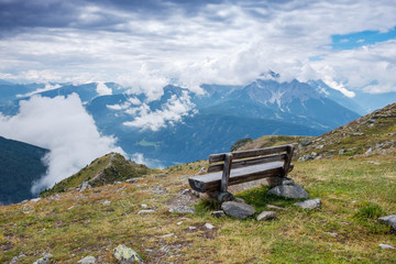 Observation deck with a bench in the Alpine mountains overlooking the valley