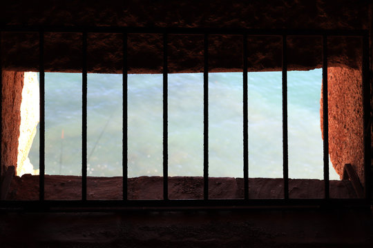 Ancient tower window with bars. Sea view. Bedesten Alanya fortress. Turkey.