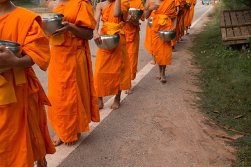 Buddhist Monks are walking to Buddhism People to Give Alms Bowl.
