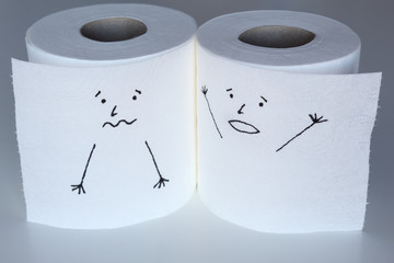 Two white toilet paper rolls sketched with a scared and a shouting faces, close to each others, representing the fright and the panic feelings