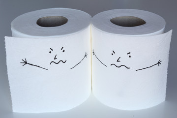 Two white toilet paper rolls sketched with furious characters close to each others, with an angry face, representing the rage feelings