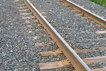 A Railway Track Made Of Metal And Wood. Rocks And Stones Are Used As A Ballast To Help Hinder Growth Of Plants And Keep A Stable Foundation For The Tracks. 
