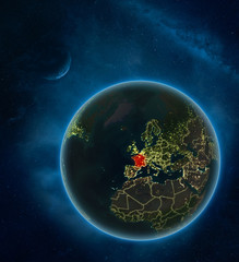 France at night from space with Moon and Milky Way. Detailed planet Earth with city lights and visible country borders.