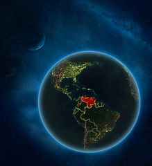 Venezuela at night from space with Moon and Milky Way. Detailed planet Earth with city lights and visible country borders.