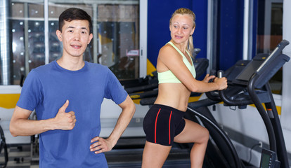 Fototapeta na wymiar Confident trainer posing at gym