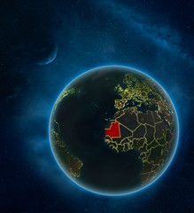 Mauritania at night from space with Moon and Milky Way. Detailed planet Earth with city lights and visible country borders.