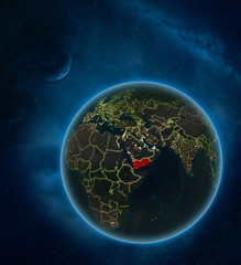 Yemen at night from space with Moon and Milky Way. Detailed planet Earth with city lights and visible country borders.