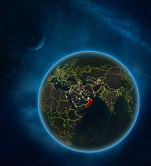 Oman at night from space with Moon and Milky Way. Detailed planet Earth with city lights and visible country borders.