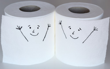 Two white toilet paper rolls sketched with two cheerful faces close to each others, representing the happiness feelings