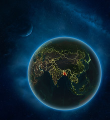 Bangladesh at night from space with Moon and Milky Way. Detailed planet Earth with city lights and visible country borders.