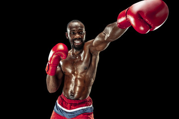 Hands of boxer over black background. Strength, attack and motion concept. Fit african american...