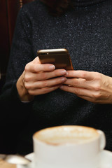 Woman use of mobile phone in coffee shop