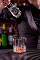 Barman show. Bartender is making cocktail at night club.