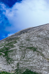 Hikers reaching mountain top, hiking uphill. Bulgaria, Vihren mountain.