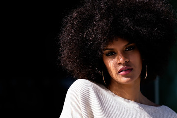 Portrait of attractive afro woman in over the wall