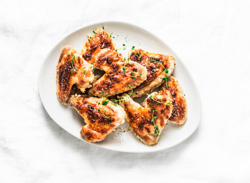 French mustard marinade roasted chicken wings - delicious appetizers, tapas on light background, top view
