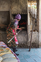 Photograph of how homemade bread is made in a wood-burning oven.
