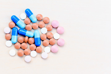 Assorted pills (medicine) on a light background. Top View.