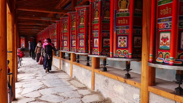 Buddhist pilgrims turning the prayer wheels, Eastern Tibet, China