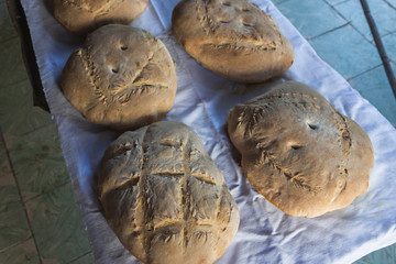 Photograph of how homemade bread is made in a wood-burning oven.