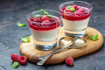 Vanilla Panna cotta with berry sauce and fresh raspberries. - obrazy, fototapety, plakaty