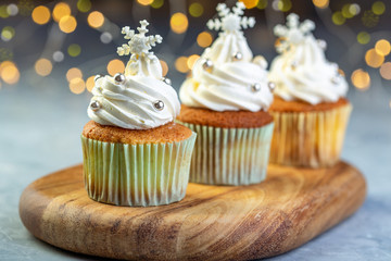Vanilla cupcakes with Christmas decor.