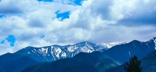 Fototapeta na wymiar Beautiful alpine ice mountains peaks with snow, summer time, blue sky background.