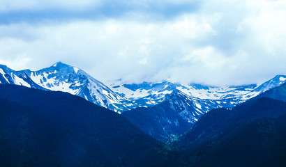 Fototapeta premium Beautiful alpine ice mountains peaks with snow, summer time, blue sky background.
