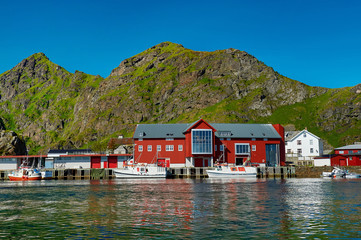 Fototapeta na wymiar Travel in Norway. Lofoten Islands. Fishing village and ships at sunset. Norwegian nature. Scandinavian trip