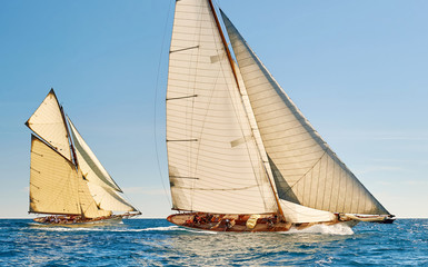 Sailing yacht race regatta. Classic sailboats in the sea under sail. Yachting sport and travel 