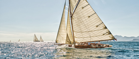 Sailing yacht race regatta. Classic sailboats in the sea under sail. Yachting sport and travel 