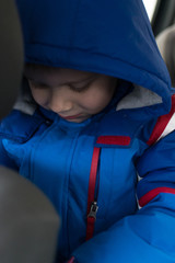 The boy tilted his head in the hood