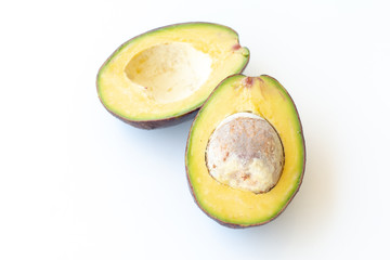 Two slices of avocado on a white background