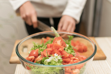 Cooking salad from fresh vegetables.