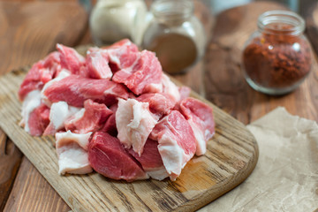 Fresh raw pork sliced on wooden background.